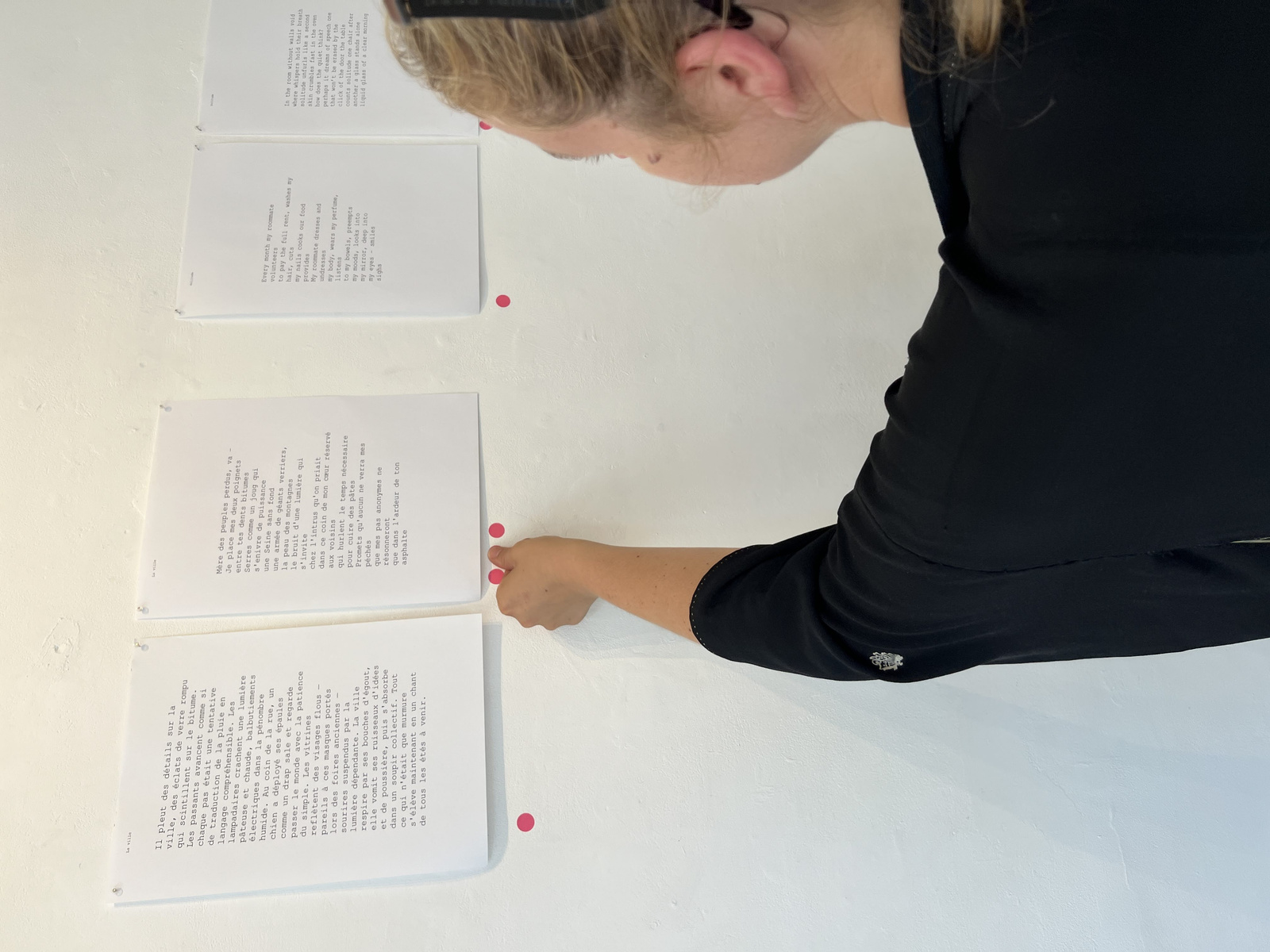 Printed poems being placed for audience viewing