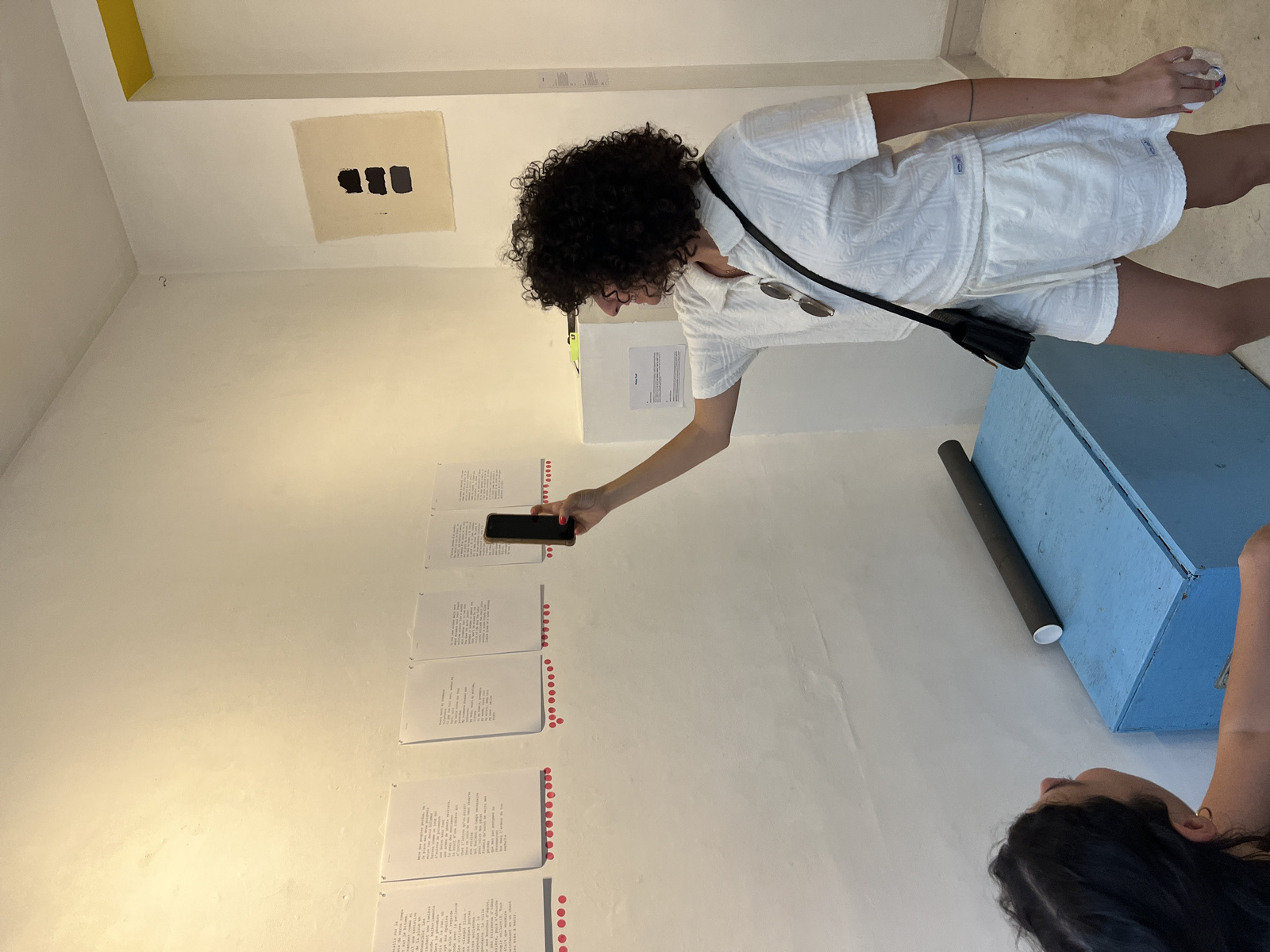 Detail of pink voting stickers on printed poems